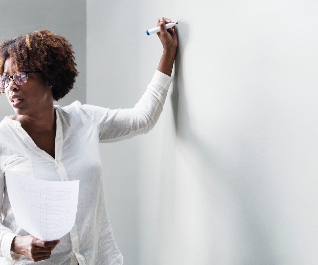 Woman writing on whiteboard