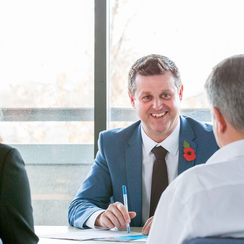 Jonathan smiling behind desk