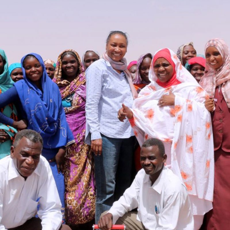 Muna among group of smiling locals