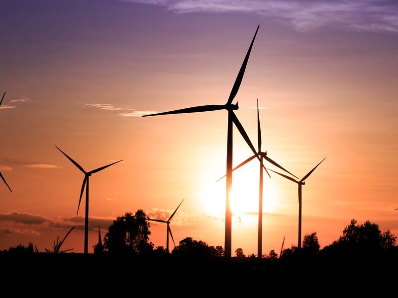 Sunsetting behing wind turbines