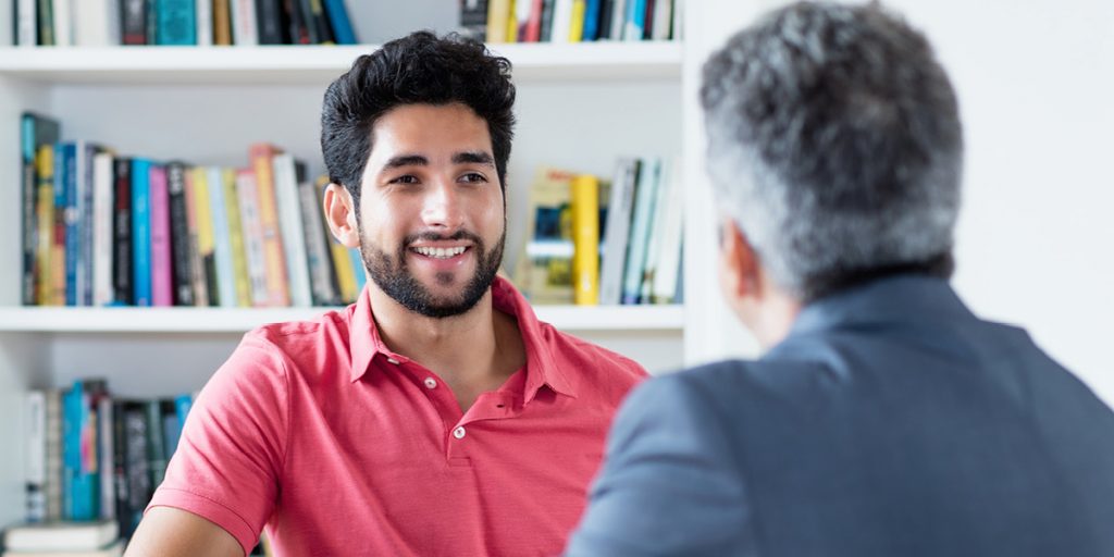 Two men sat in meeting