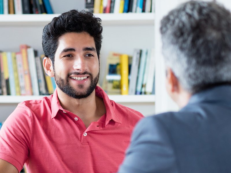 Two men sat in meeting
