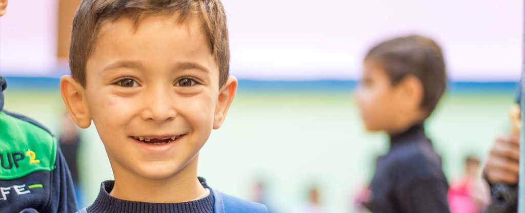 Young boy smiling looking at camera