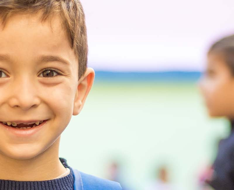 Young boy smiling looking at camera