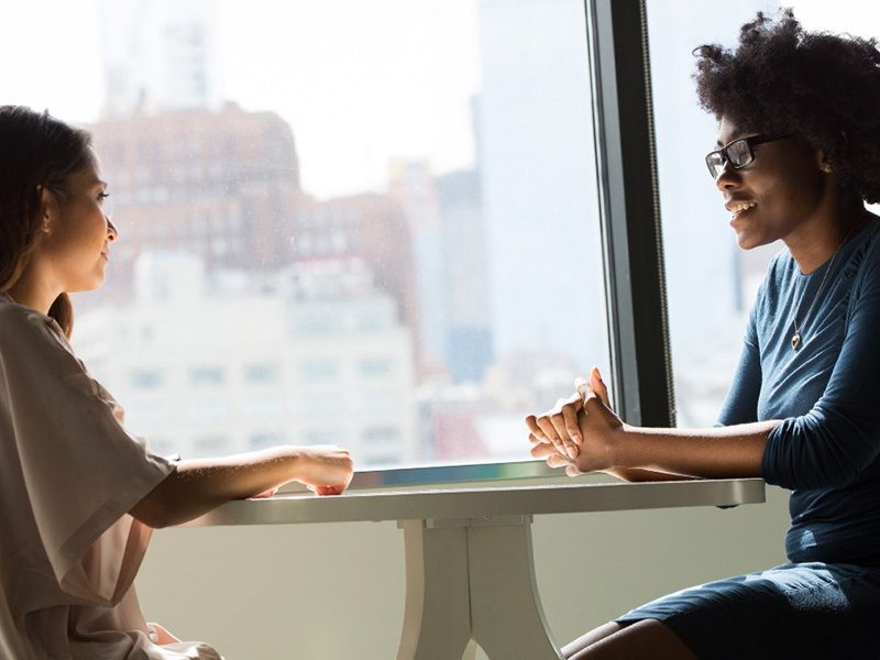 Two women sat in conversation