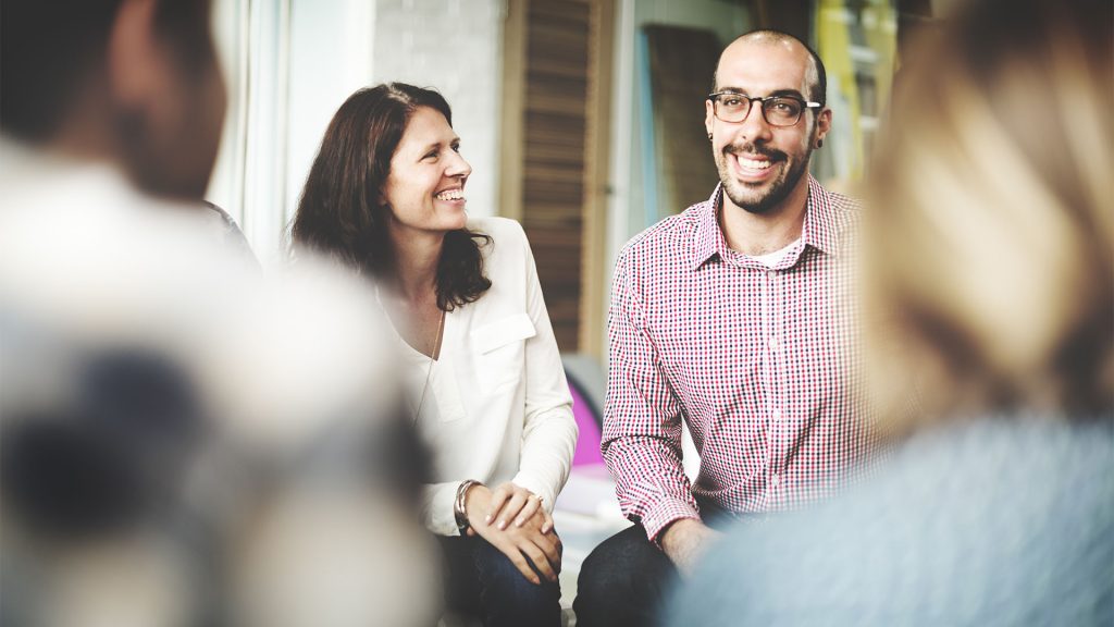 Group of people smiling at work meeting