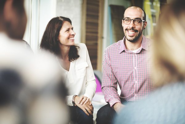 Group of people smiling at work meeting