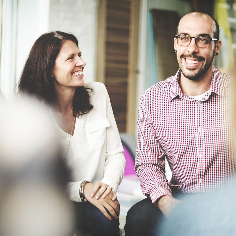 Group of people smiling at work meeting