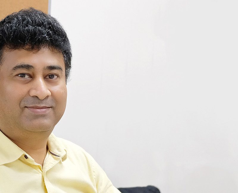 Angshu sat at his desk