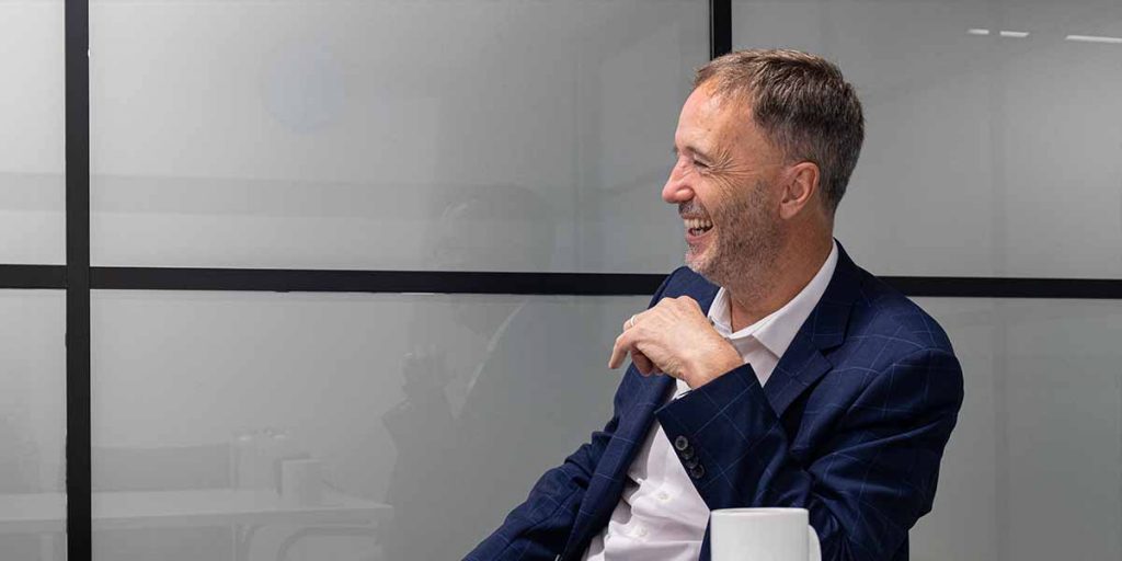 David sat smiling in meeting