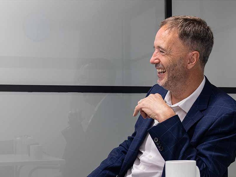 David sat smiling in meeting