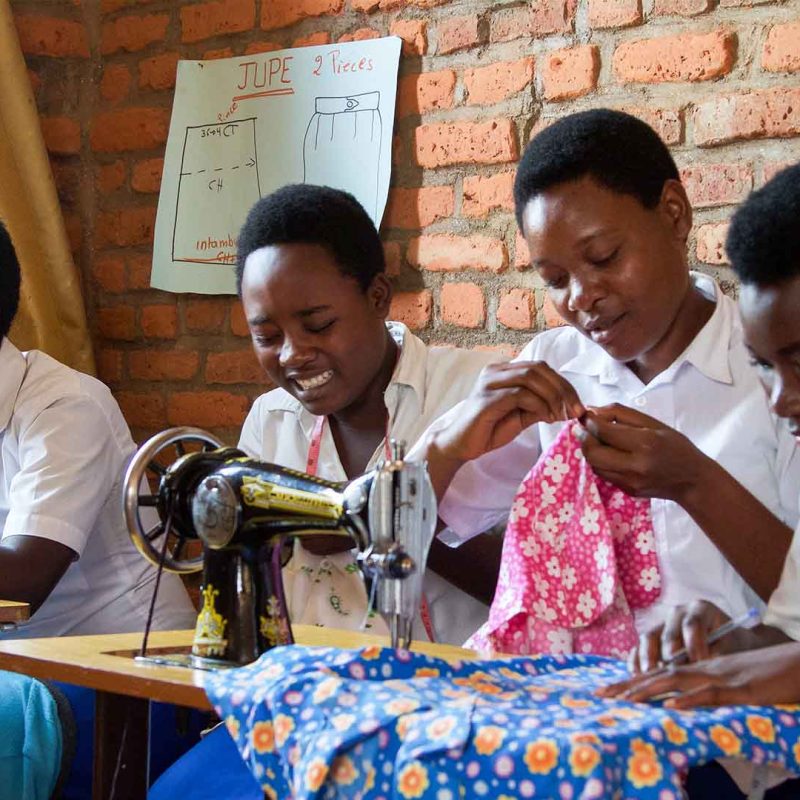 Group of students in African classroom working on sewing machines