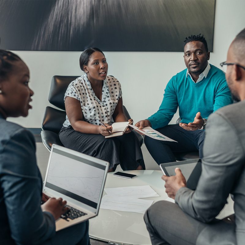 Group of people sat in meeting discussing work