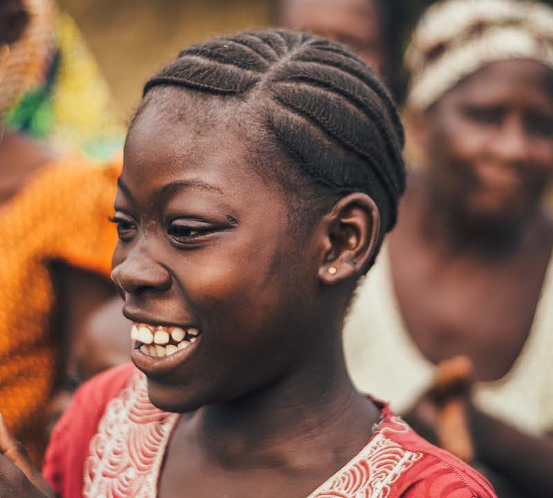 Sierra Leonian women looking at the ground and smiling