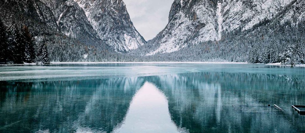 Wintry mountain range reflected in river