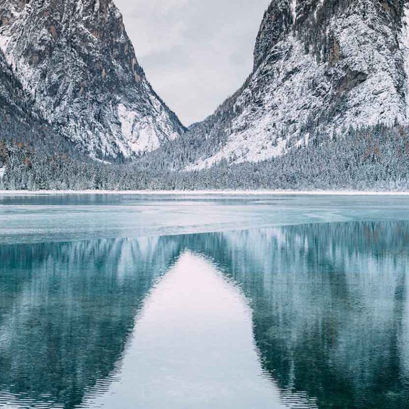 Wintry mountain range reflected in river