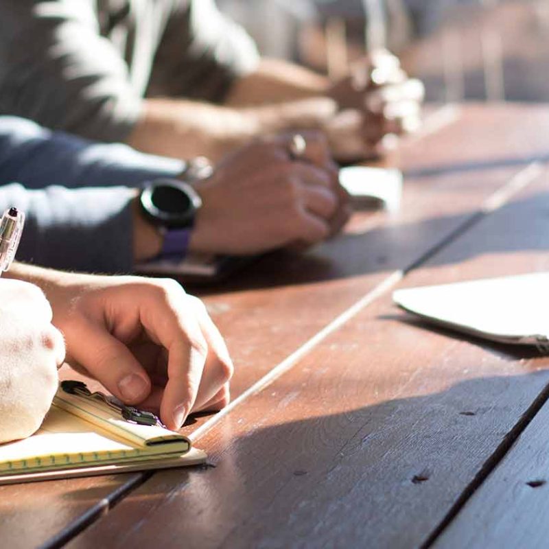 Group of people sitting around a desk planning
