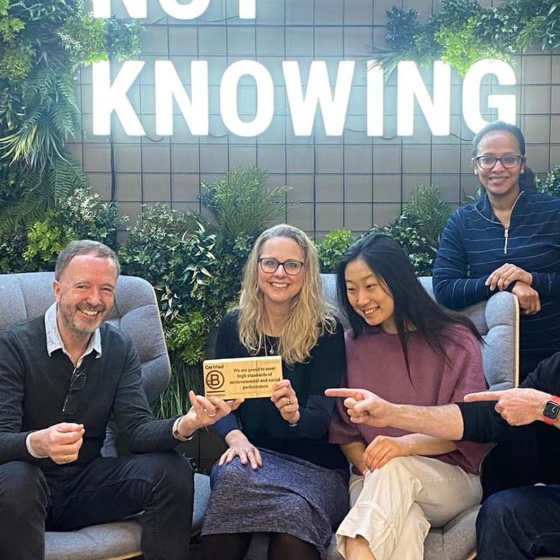 Oxford HR team holding B Corp logo