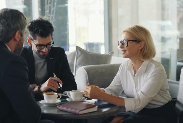Three senior leaders in meeting
