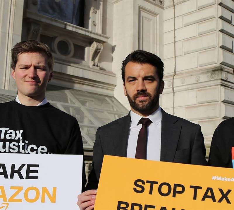 Activists from Tax Justice UK protesting on the streets of London
